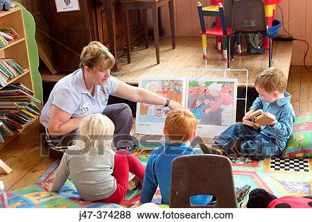 Group of young 3 year old children learning to read with teacher at school View Large Photo Image Stock Photo - Group of young 3 year old children learning to read with teacher at school. Fotosearch