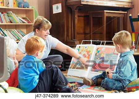 Group of young 3 year old children learning to read with teacher at school View Large Photo Image Stock Photo - Group of young 3 year old children learning to read with teacher at school. Fotosearch