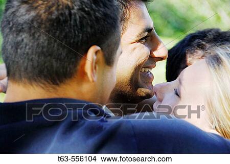 group of young adults embracing togethe View Large Photo Image Picture - group of young adults embracing togethe. Fotosearch