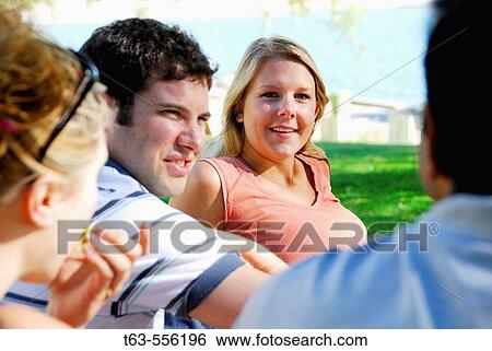 group of young adults having discussion, communication View Large Photo Image Stock Photograph - group of young adults having discussion, communication. Fotosearch