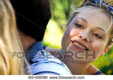 group of young adults in the park together View Large Photo Image Stock Photo - group of young adults in the park together. Fotosearch
