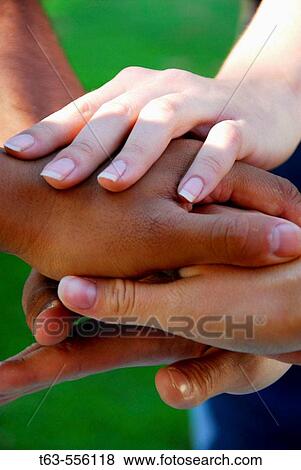 group of young adults stacking hands on top of each other View Large Photo Image Stock Photo - group of young adults stacking hands on top of each other. Fotosearch