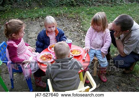 Group of young children having a picnic in the garden View Large Photo Image Stock Image - Group of young children having a picnic in the garden. Fotosearch