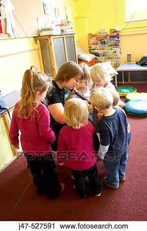 Group of young children playing together at nursery, learning music View Large Photo Image Stock Image - Group of young children playing together at nursery, learning music. Fotosearch