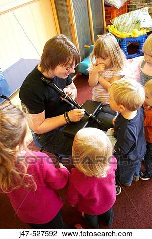 Group of young children playing together at nursery, learning music View Large Photo Image Stock Image - Group of young children playing together at nursery, learning music. Fotosearch