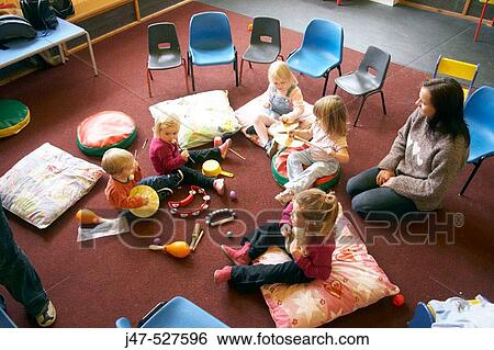 Group of young children playing together in a music class View Large Photo Image Stock Photograph - Group of young children playing together in a music class. Fotosearch