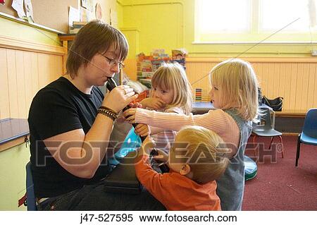 Group of young children playing together at nursery, learning music View Large Photo Image Stock Photography - Group of young children playing together at nursery, learning music. Fotosearch