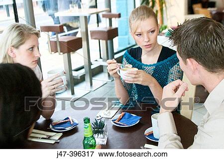 Group of young people, having a chat in a caf? View Large Photo Image Stock Photo - Group of young people, having a chat in a caf?. Fotosearch
