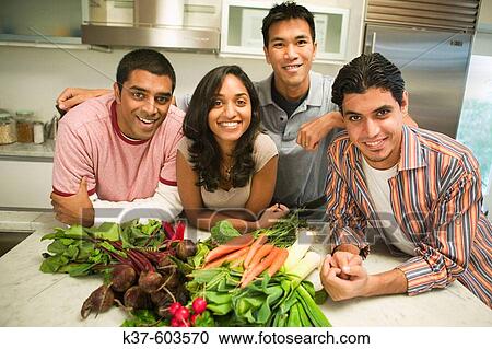 Group of young people of mixed ethnicities holding vegetables in kitchen View Large Photo Image Stock Image - Group of young people of mixed ethnicities holding vegetables in kitchen. Fotosearch