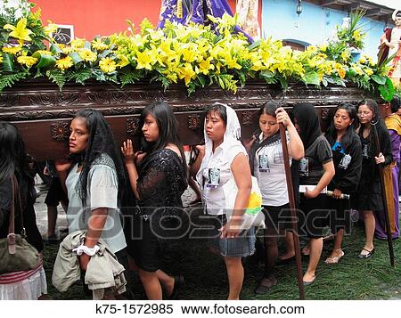 Stock Photography - Group of young women carrying float of the Virgin Mary during Holy Week. Fotosearch