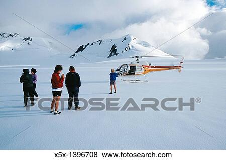 Group standing outside helicopter on the ice of the neve of Franz Josef Glacier, New Zealand View Large Photo Image Stock Photo - Group standing outside helicopter on the ice of the neve of Franz Josef Glacier, New Zealand. Fotosearch