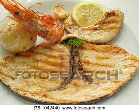 Stock Image - Grouper, shrimp and potatoes braised. Fotosearch