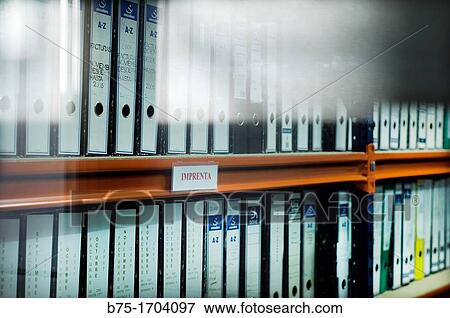 Stock Photo - grupo de archivadores en una estanteria de oficina, group of archives filing a Office shelf,. Fotosearch