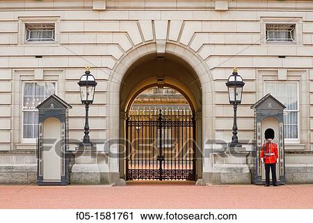 Stock Image - Guard posted outside of Buckingham Palace. London, England, UK.. Fotosearch