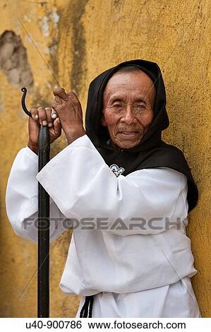 Stock Photograph - Guatemala, Antigua, Man dressed for holy week procession (MR). Fotosearch