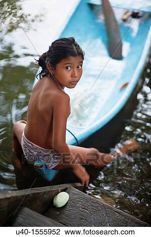 Guatemala, Mayan girl with dug out canoe View Large Photo Image Stock Image - Guatemala, Mayan girl with dug out canoe. Fotosearch