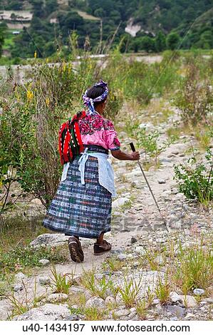 Guatemala, Mayan woman walking on dirt road View Large Photo Image Stock Photo - Guatemala, Mayan woman walking on dirt road. Fotosearch