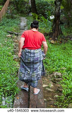 Stock Image - Guatemala, Mayan woman walking on path. Fotosearch