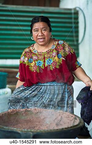 Stock Image - Guatemala, Mayan woman with pot of beans. Fotosearch