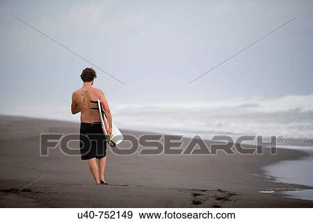 Guatemala, Paredon beach, man with surfboard View Large Photo Image Stock Photo - Guatemala, Paredon beach, man with surfboard. Fotosearch