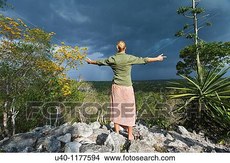 Picture - Guatemala, Peten, El Mirador basin, Woman on top of Temple Los Monos. Fotosearch