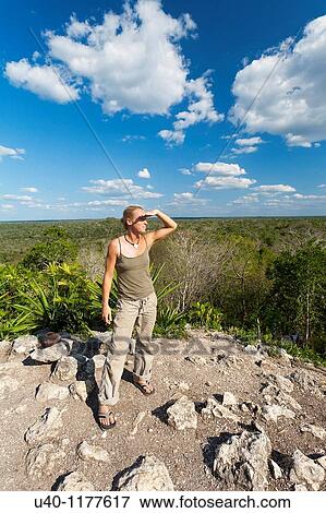 Guatemala, Peten, El Mirador Basin, woman looking out from top of Temple View Large Photo Image Stock Photo - Guatemala, Peten, El Mirador Basin, woman looking out from top of Temple. Fotosearch