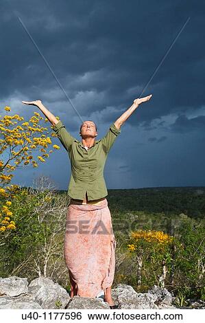 Stock Photograph - Guatemala, Peten, El Mirador basin, Woman on top of Temple Los Monos. Fotosearch