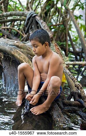 Guatemala, Rio Dulce, boy fishing in river View Large Photo Image Stock Photo - Guatemala, Rio Dulce, boy fishing in river. Fotosearch