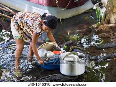 Guatemala, Rio Dulce, girl washing dishes in River View Large Photo Image Stock Image - Guatemala, Rio Dulce, girl washing dishes in River. Fotosearch