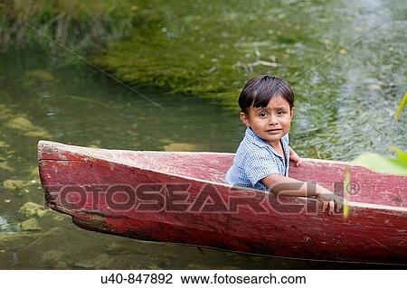 Guatemala, Rio Dulce, young boy in canoe View Large Photo Image Stock Image - Guatemala, Rio Dulce, young boy in canoe. Fotosearch