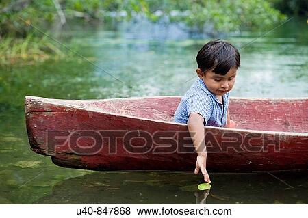 Guatemala, Rio Dulce, young boy in canoe View Large Photo Image Stock Photo - Guatemala, Rio Dulce, young boy in canoe. Fotosearch