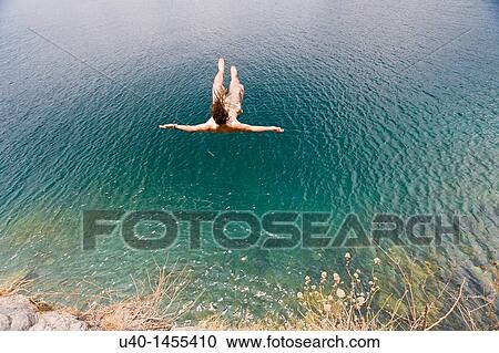 Guatemala, San Marcos La Laguna, man jumping off cliff View Large Photo Image Stock Image - Guatemala, San Marcos La Laguna, man jumping off cliff. Fotosearch
