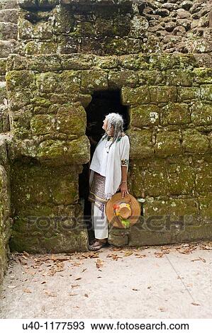 Stock Image - Guatemala, Tikal, Shaman in temple doorway. Fotosearch