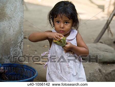 Guatemala, young girl eating fresh cacao View Large Photo Image Stock Image - Guatemala, young girl eating fresh cacao. Fotosearch