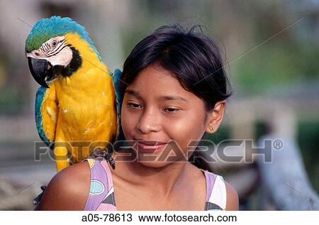 Guayo girl with macaw. Orinoco. Venezuela. View Large Photo Image Stock Image - Guayo girl with macaw. Orinoco. Venezuela.. Fotosearch