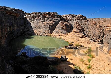 Guelta, waterhole at Dider Valley, Tassili n? Ajjer National Park, Unesco World Heritage Site, Illizi Province, Algeria, Sahara, North Africa View Large Photo Image Picture - Guelta, waterhole at Dider Valley, Tassili n? Ajjer National Park, Unesco World Heritage Site, Illizi Province, Algeria, Sahara, North Africa. Fotosearch