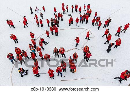 Stock Image - Guest from the Lindblad Expedition ship National Geographic Explorer enjoy the fast ice in Charlotte Bay, Antarctica, Southern Ocean.. Fotosearch