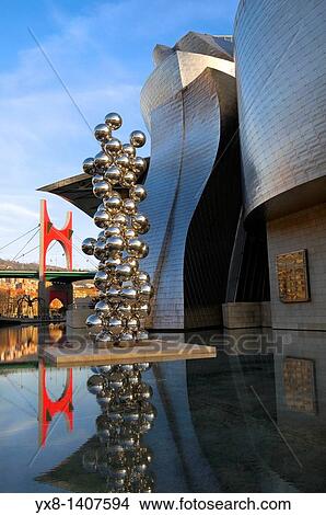 Picture - Guggenheim Museum and the scuplture Tall tree and the eyeo by Anish Kapoor with La Salveo bridge on the bagkground, Bilbao, Vizcaya, Basque Country, Spain, Europe. Fotosearch