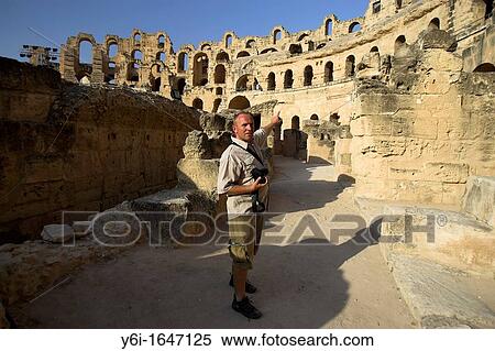 Stock Photography - Guide points out feature at El Jem colosseum Tunisia finest Roman remains in Africa. Fotosearch