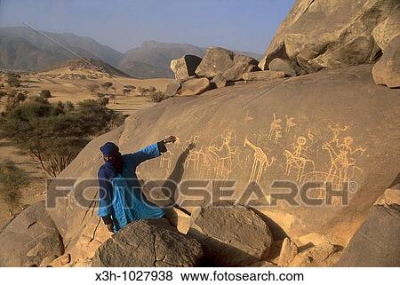 guide showing rock art in Mountains of A? r, Niger, Western Africa View Large Photo Image Stock Photo - guide showing rock art in Mountains of A? r, Niger, Western Africa. Fotosearch