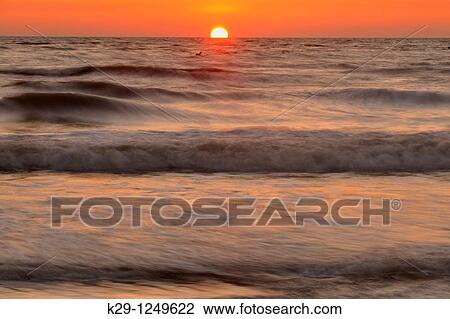 Stock Image - Gulf beach and surf after sunset. Fotosearch