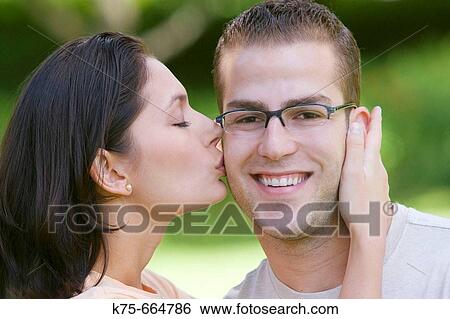 Guy gets kiss from beautiful woman View Large Photo Image Stock Photograph - Guy gets kiss from beautiful woman. Fotosearch