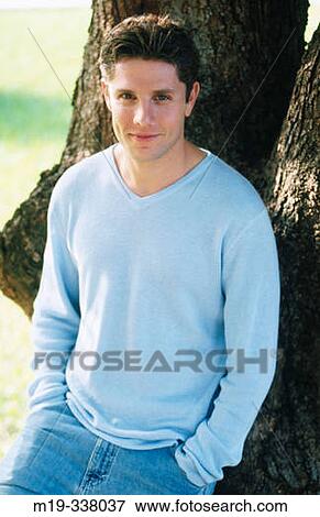 guy relaxed against a tree View Large Photo Image Stock Photo - guy relaxed against a tree. Fotosearch