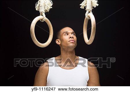 Stock Photo - Gymnast man on rings. Fotosearch