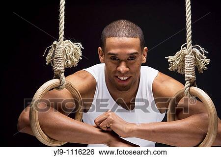 Gymnast man on Rings. View Large Photo Image Stock Photograph - Gymnast man on Rings.. Fotosearch
