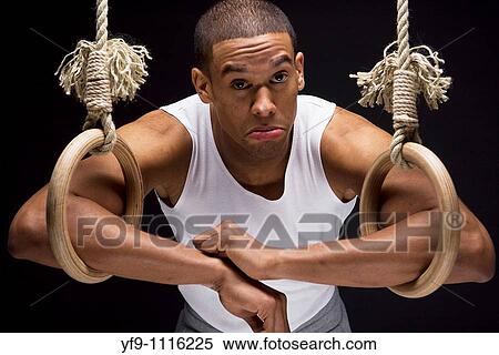 Gymnast man on Rings. View Large Photo Image Stock Photography - Gymnast man on Rings.. Fotosearch