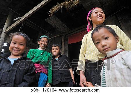 H? mong family in the doorway of his home, mountain village around Sa Phin, Ha Giang province, northern Vietnam, southeast asia View Large Photo Image Picture - H? mong family in the doorway of his home, mountain village around Sa Phin, Ha Giang province, northern Vietnam, southeast asia. Fotosearch