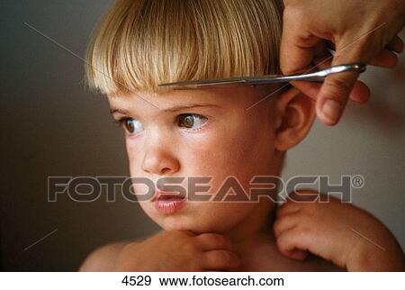 Stock Photo - Hair cutting on kid. Fotosearch
