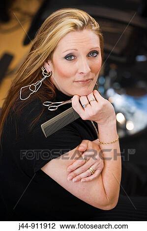 Hair dresser with comb and scissors, portrait View Large Photo Image Stock Image - Hair dresser with comb and scissors, portrait. Fotosearch