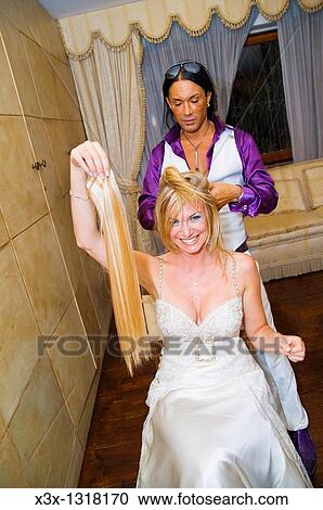 Hair stylist fixing woman hair extensions at hair salon View Large Photo Image Stock Image - Hair stylist fixing woman hair extensions at hair salon. Fotosearch